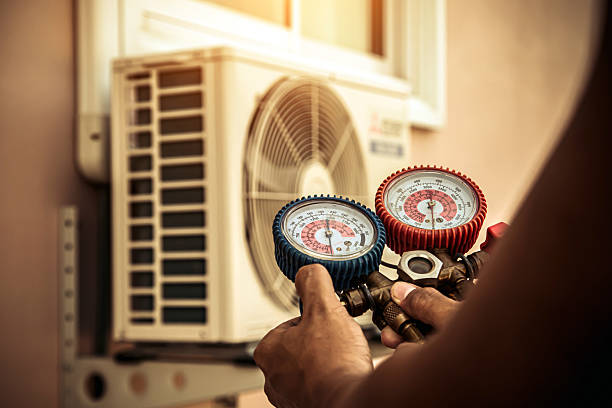 Professional Air Conditioning Service technician working in Wiggins, CO